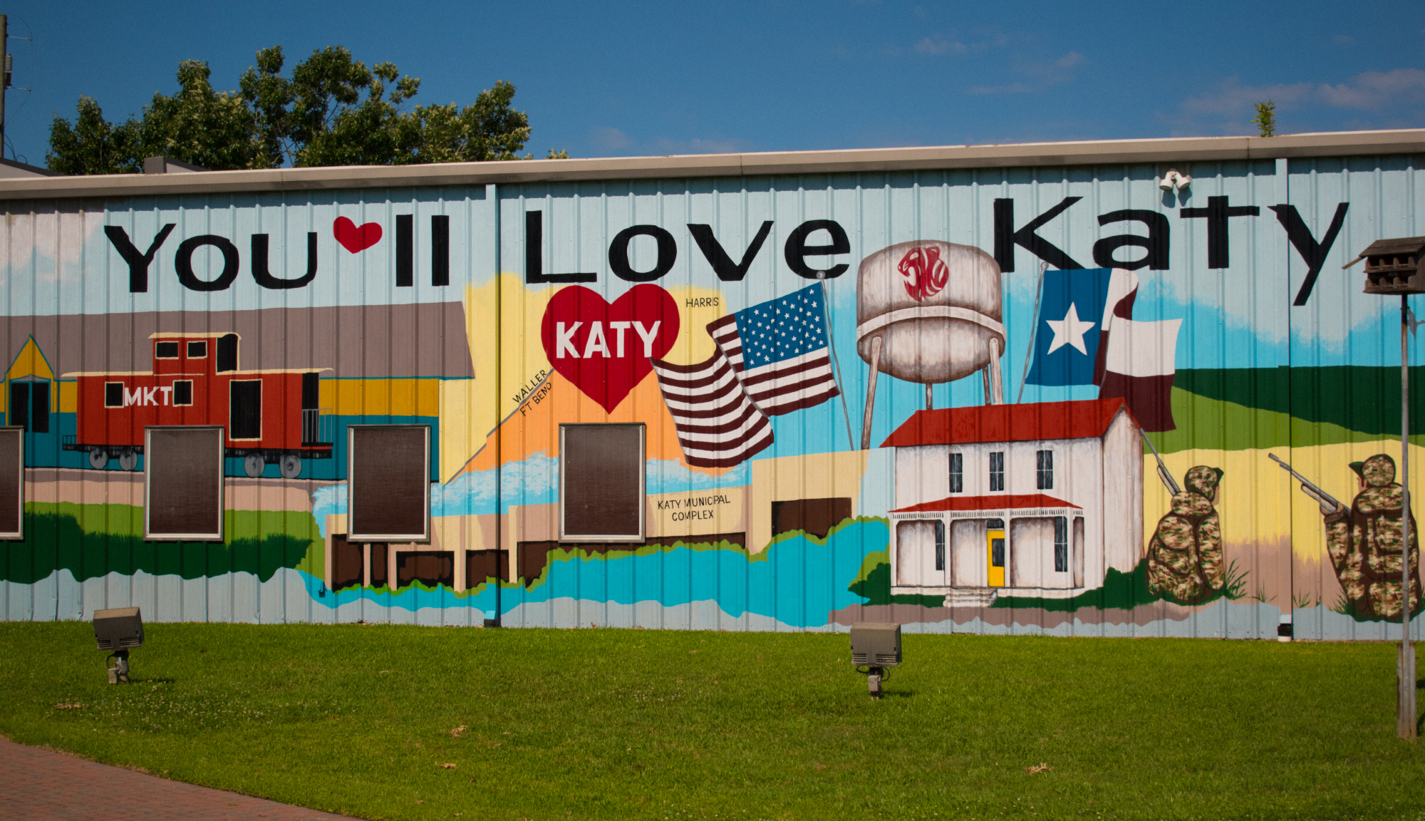 Exterior mural on building. Large letters saying "you'll love Katy"